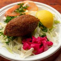 Kibbeh Ball · Ground beef, cracked wheat stuffed with chopped meat, onion, pine nuts, and spices.