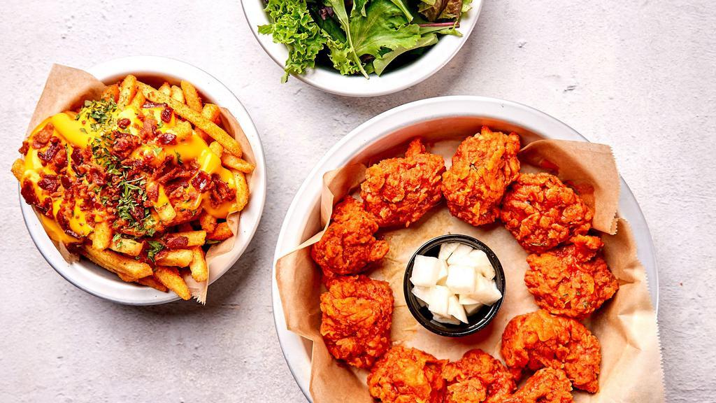 Boneless Wing Combo · Ten pc boneless wings in a flavor of your choice with fries and side salad.