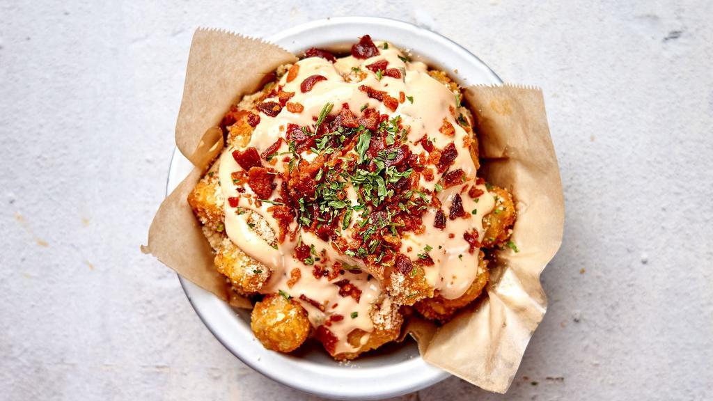 Crack Tots · Crispy tater tots with our Crack Sauce, bacon crumble, and chives.