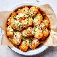 Parmesan Truffle Tots · Crispy tater tots with freshly grated parmesan cheese, white truffle oil and chives.
