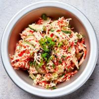 Spicy Crab Salad · Shredded Japanese kani gently tossed with scallions, pickled cucumbers and sriracha aioli ga...