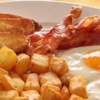 Egg And Bacon Or Sausage · Two eggs and bacon or sausage with home fries and toast.