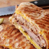 Cuban Sandwich · Ham, Swiss cheese, pork, mustard, pickles, mojo sauce with Cuban bread.