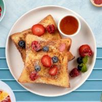 Berry French Toast · Fresh bread battered in egg, milk, and cinnamon cooked until spongy and golden brown. Topped...