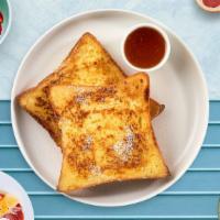 Texas French Toast · Fresh bread battered in egg, milk, and cinnamon cooked until spongy and golden brown. Topped...
