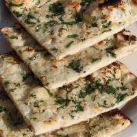 R3 Garlic Naan · Plain Naan cooked in tandoor topped with garlic