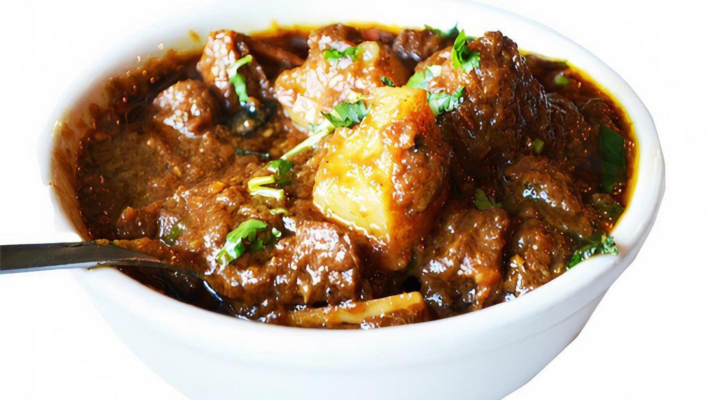M22 Goat Vindaloo · Goat cubes cooked in a spicy sauce with potatoes and a touch of vinegar.