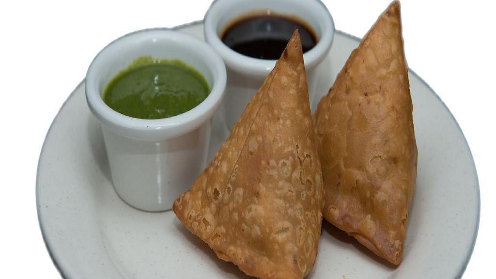 B1 Samosa(2) Plate · Fried pastry with a savory spiced potatoes with herbs filling served with mint and tamarind chutney