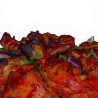 Tc Tandoori Chicken · Chicken leg quarters marinated overnight in spices & herbs, served with grilled onions, pepp...