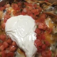 Ground Beef Nachos · Freshly made corn chips smothered with black or pinto beans melted Jack and Cheddar cheese, ...