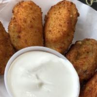 Jalapeño Poppers · Vegetarian. Jalapeño poppers stuffed with Cheddar cheese lightly breaded and served on a bed...