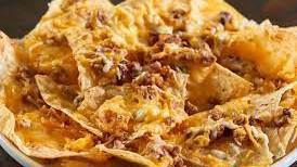 Nachos · A heaping pile of corn tortilla chips topped with, queso, cheese, sour cream, salsa and one ...