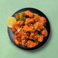 Cauli Manchurian Bites · Spiced batter-fried cauliflower, sautéed with ginger, garlic, onions, and tossed in Indo-Chi...