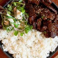 Galbi Rice / 갈비덮밥 · Traditional marinated beef short ribs over rice on a sizzling stone pan.