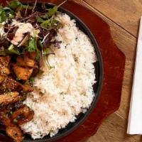 Terriyaki Chicken / 데리야끼치킨 · Marinated teriyaki chicken over rice on a sizzling stone pan.