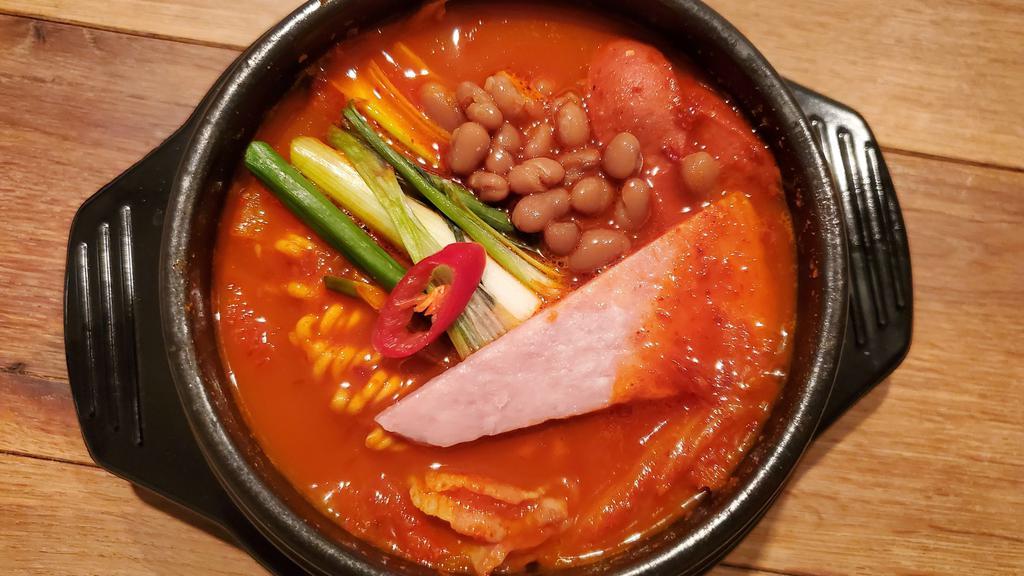 Budae Jjigae / 부대찌개 · Spicy. Spicy stew with sausage, ham, cream cheese & baked bean with ramen noodle.