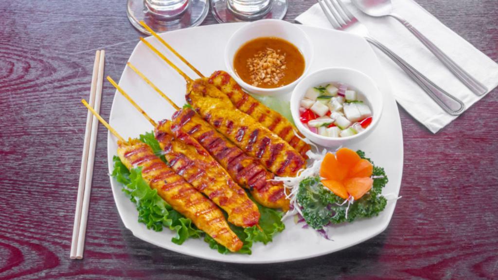  Satay Chicken · Sliced chicken marinated in Thai spices and grilled to perfection on bamboo skewers. Served with cucumber salad and peanut sauce.