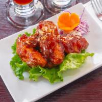 Chicken Wings · Deep fried chicken wings glazed with sweet and sour sauce.
