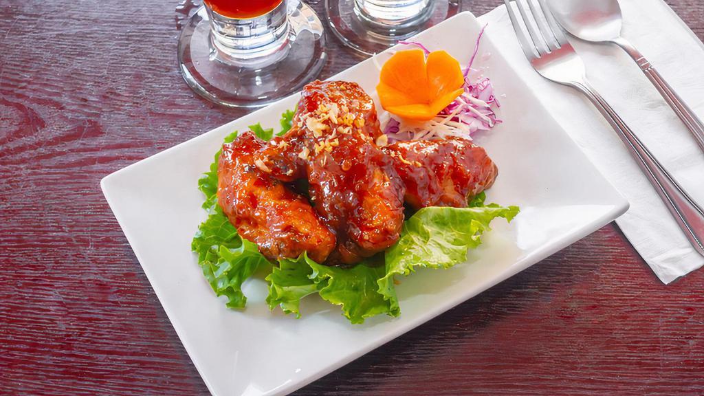 Chicken Wings · Deep fried chicken wings glazed with sweet and sour sauce.