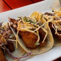 Pescado Tacos · Top menu item. Beer buttered tilapia fish, topped with cabbage slaw, chipotle aioli, and avo...