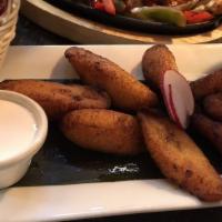 Papas Provensal · Coated cilantro garlic cotija and chile fried potatoes.