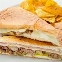 Sandwich Cubano · Classic cuban pressed sandwich of roast pork, ham, swiss cheese, pickles and mustard.