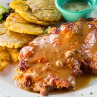 Pollo Guantanamera · Half boneless chicken marinated in garlic infused Cuban sauce and served with tostones or ri...