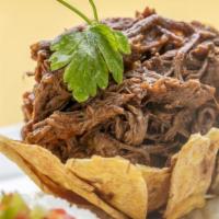 Ropa Vieja · Shredded skirt steak braised in a garlic sauce of fresh tomatoes, sliced onions and mixed pe...