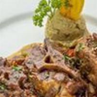 Rabo Encendido · Tender chunks of oxtail braised in a red wine sauce with mashed sweet plantain.