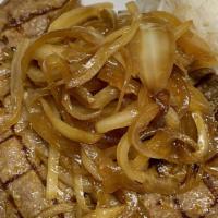 Bistec De Palomilla · Traditional cuban steak (very thin) with sauteed onions.