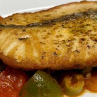 Salmon Bayamo · Salmon steak sauteed in a white wine with onions, peppers, capers, anchovies and tomato sauce.