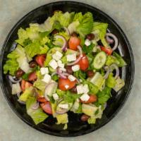 Greek Salad · A medley of romaine, iceberg, tomatoes, cucumbers, green peppers, red onions, cubed feta, an...
