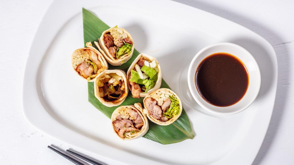 Duck Roll · Shredded boneless duck, scallion, cucumber, carrot and mix green wrap with tortilla with hoisin sauce, sweet and chili sauce.