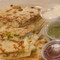 Quesadilla · Two flour tortillas with grilled chicken and shredded mozzarella cheese, sautéed mushrooms, ...