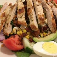 Cobb Salad · Grilled chicken breast, avocado, bacon, cucumber, corn, crumbled bleu cheese and sliced egg ...