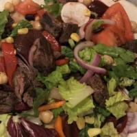 Steakhouse Chopped Salad · Perfectly marinated steak with roasted beets, sweet corn, red peppers, chickpeas, black bean...