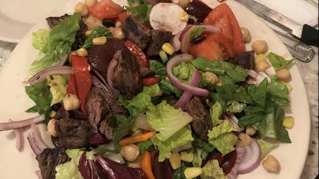 Steakhouse Chopped Salad · Perfectly marinated steak with roasted beets, sweet corn, red peppers, chickpeas, black beans, red onion, cucumbers, roma tomatoes and romaine hearts. Served with our house-made honey balsamic vinaigrette dressing.