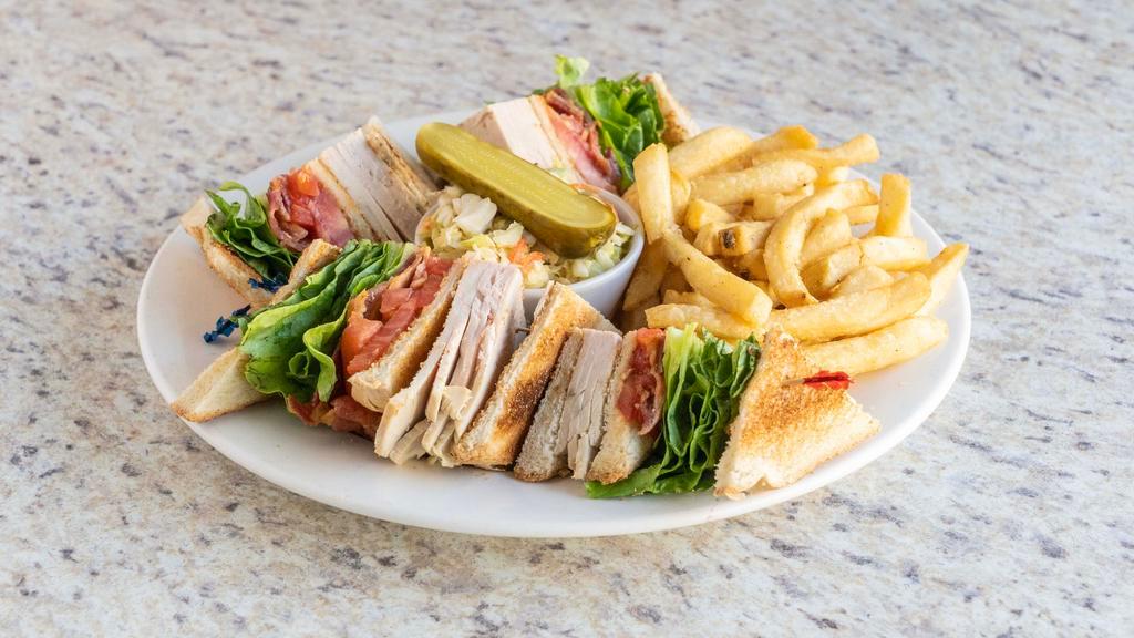 Turkey Club Sandwich · Fresh turkey breast, bacon, lettuce and tomato served with French fries.