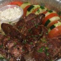 Greek Loukaniko · Grilled sausage, served with pita bread, tomatoes, cucumbers, and tzatziki dip.
