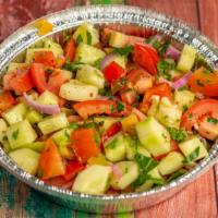 Shepherd Salad · Red vinegar and olive oil are mixed with fresh tomatoes, cucumber, green pepper, parsley, di...