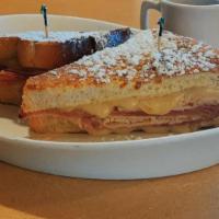Monte Cristo · French toast, melted Swiss cheese, ham, and turkey. Served with warm maple syrup and topped ...