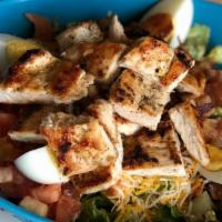 Cobb Salad · Grilled chicken, lettuce, tomatoes, cheddar cheese, hard boiled egg, and bacon. Tossed in a ...