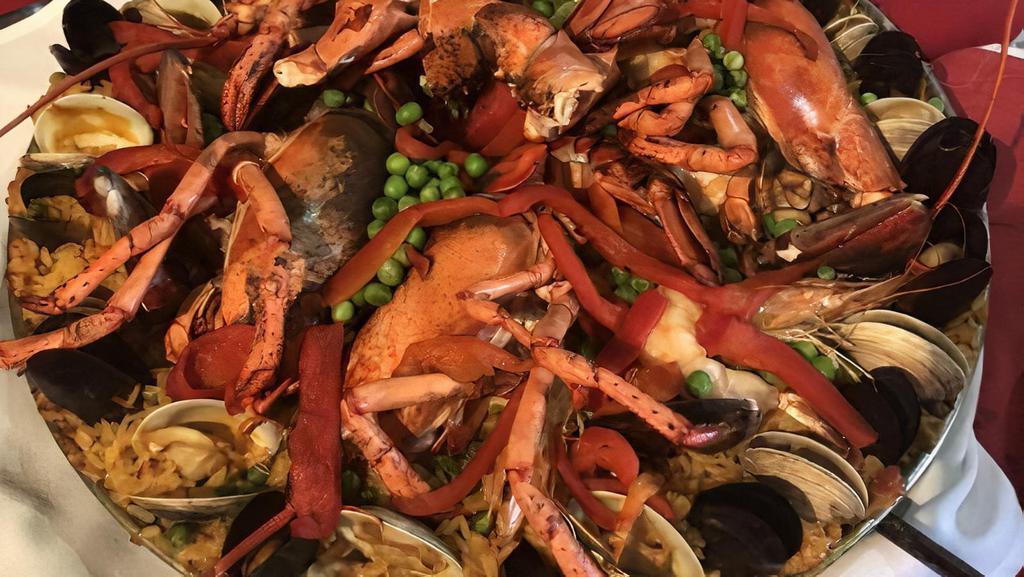 Paella Valenciana (Per Person) · Lobster tail, shrimp, clams, mussels, chicken, chorizo, sofrito, saffron rice.