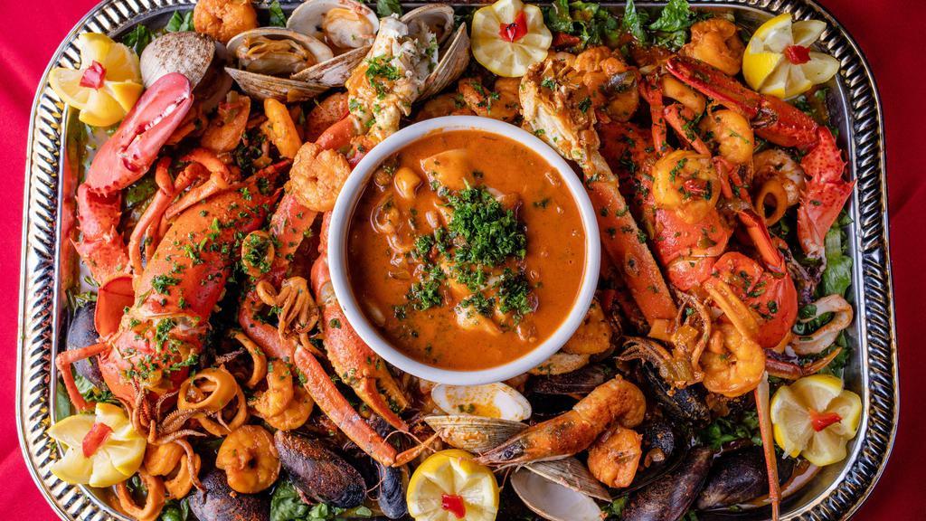 Parillada De Mariscos (2P) · Grilled lobster, clams, mussels, shrimp, filet of sole, snow crab leg, and crab stuffed mushrooms