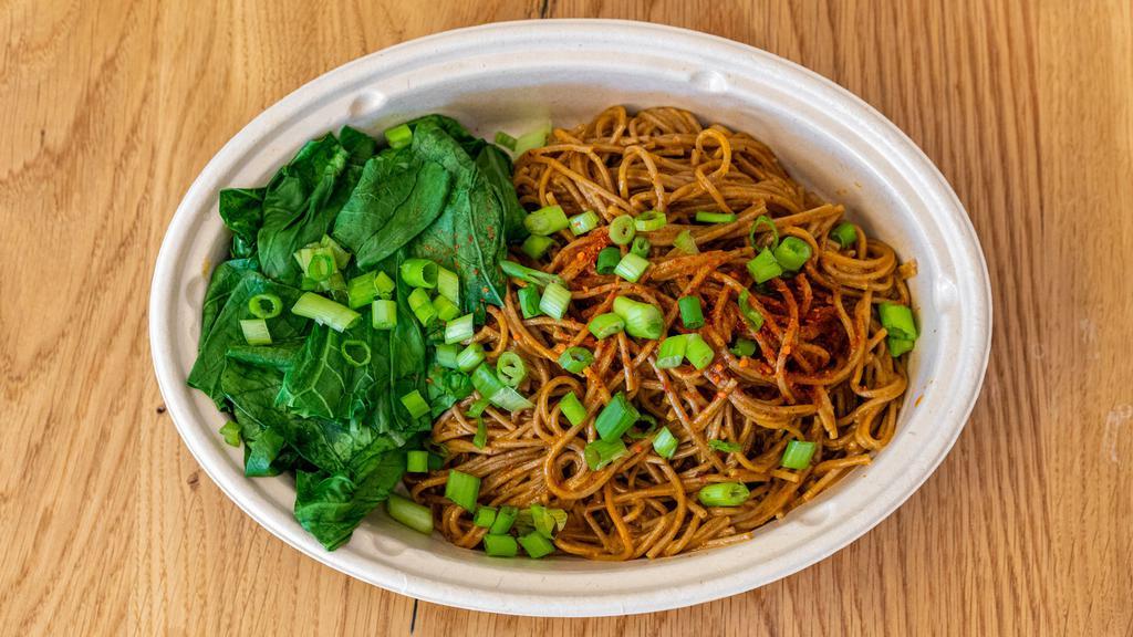 Spicy Dan Dan Noodles · Buckwheat soba noodles, baby bok choy, scallions, tahini, and homemade garlic chili oil. Very spicy, and not for the faint of heart.