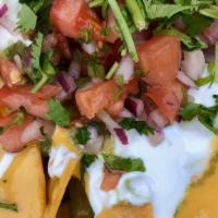 Nachos · Classic nachos with melted cheese, pico de gallo, beans, and your choice of toppings.