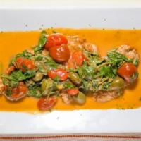Veal Scallopini · In a white lemon sauce with arugula, cherry tomato, and caper berries.