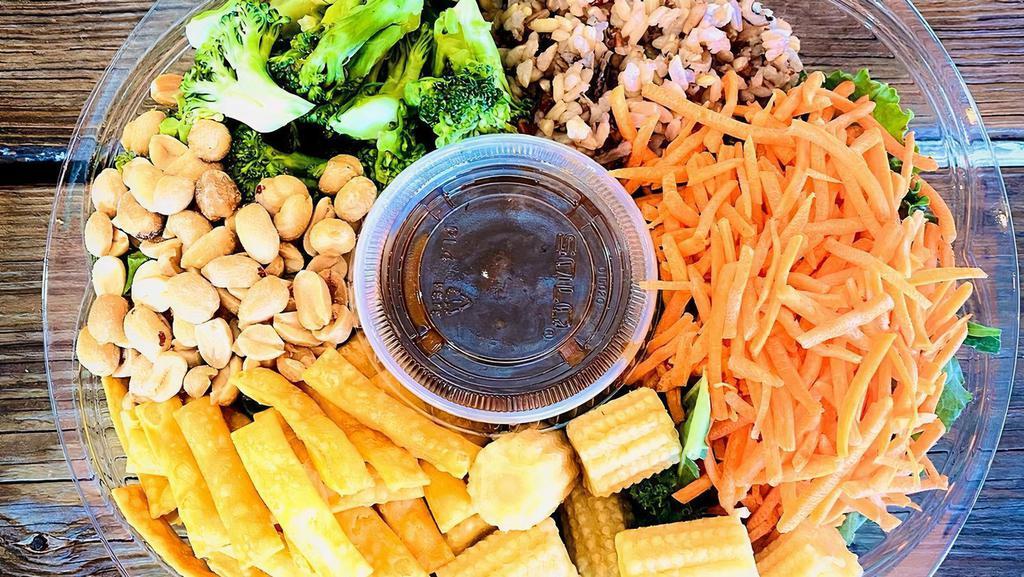 Asian Bowl · Brown rice, kale, broccoli, shredded carrots,baby corn, chopped peanuts, crispy Chinese noodles, sesame seeds, Asian sesame vinaigrette.