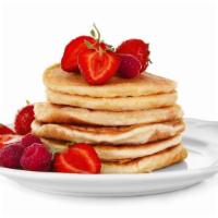 Strawberry Pancakes · Fluffy, buttery pancakes marbled and topped with fresh, sweet strawberries. Served with real...