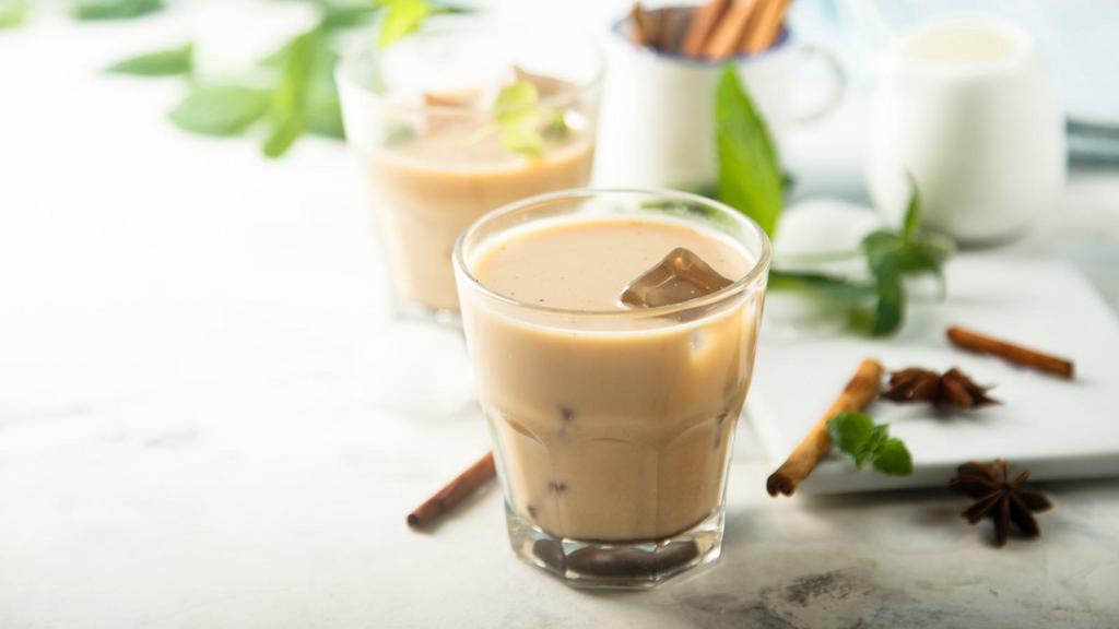 Iced Chai Latte · Aromatic, spiced chai tea with milk over ice.